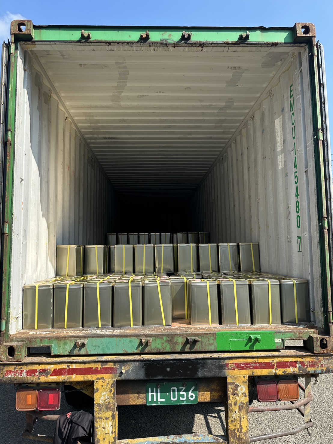 Container loaded with strawberry jam tins
